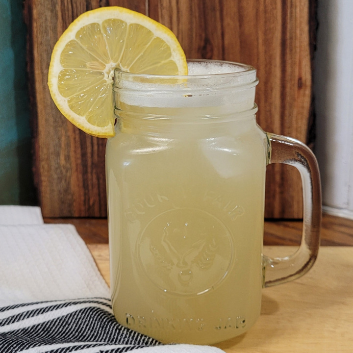 Lemon on a glass rim of lemonade